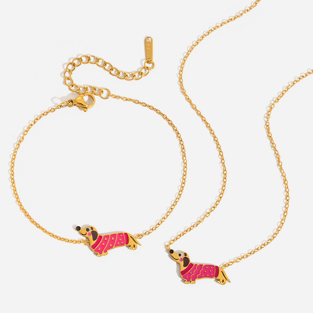 Bianca pink dachshund necklace and bracelet set laid out on a white background