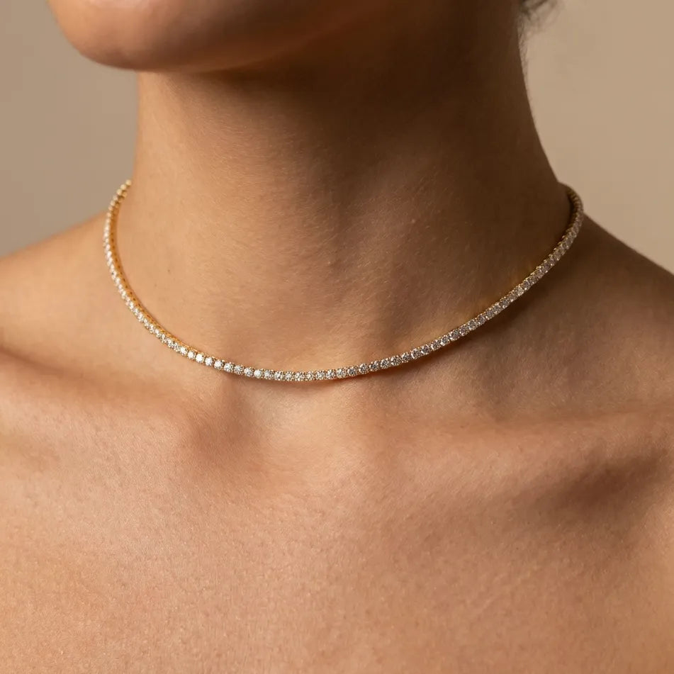 Woman wearing the Sophie Lumière gold tennis choker, a line of crystals at the throat