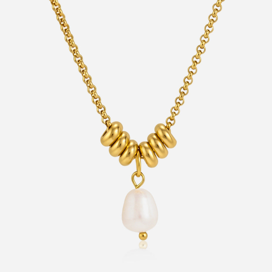Mathilde freshwater pearl drop under six gold rondelles on a gold rolo chain, light background