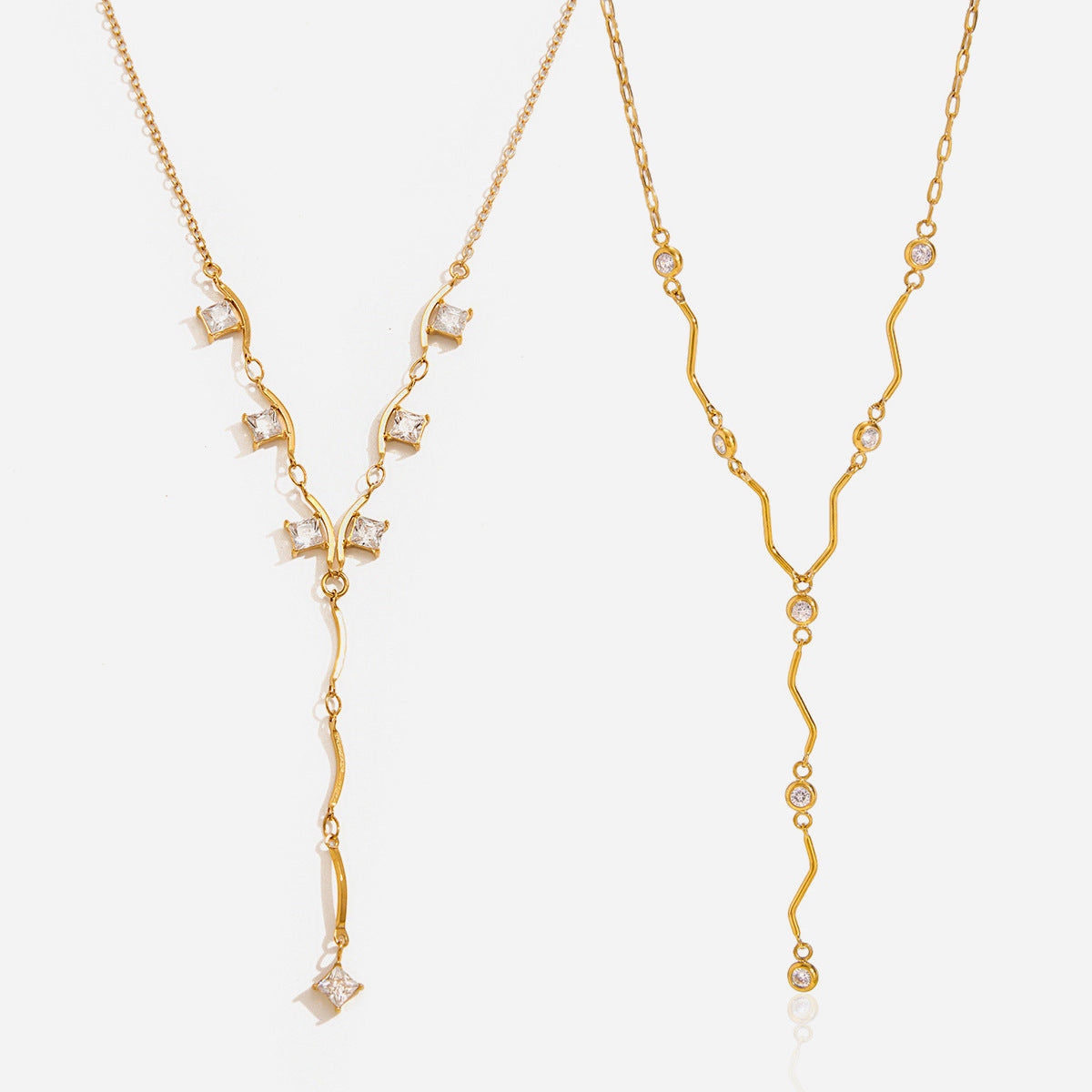 Ondine wave crystal Y necklace on the right, next to the Gemma square crystal necklace on white