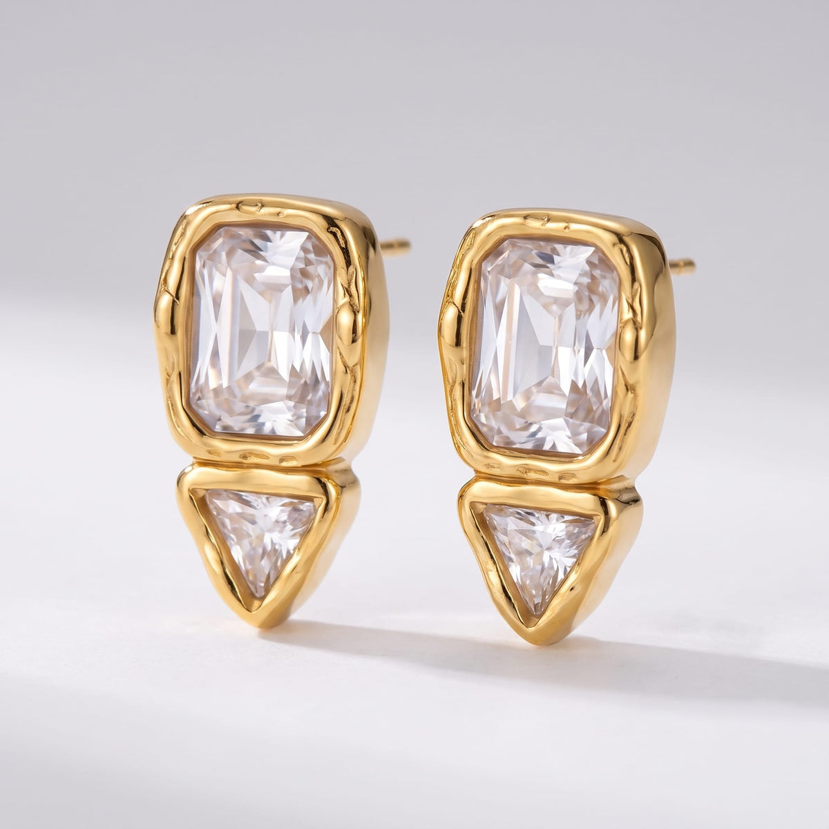 Sidonie emerald-cut crystal gold earrings on a plain white surface