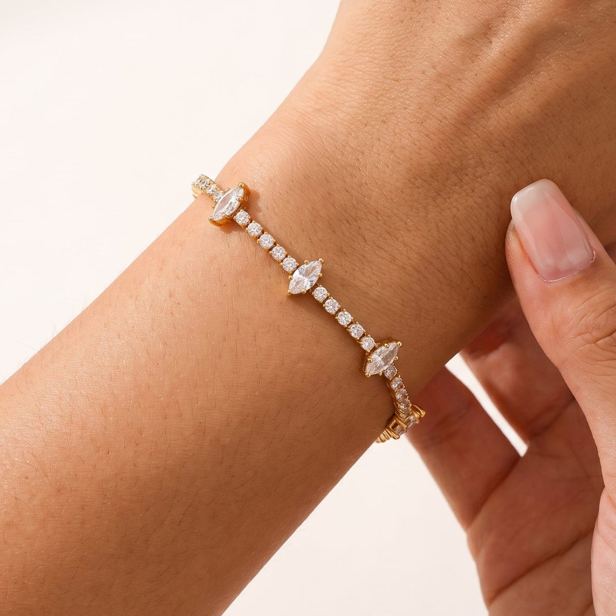 Woman wearing the Sienna marquise tennis gold bracelet on the wrist