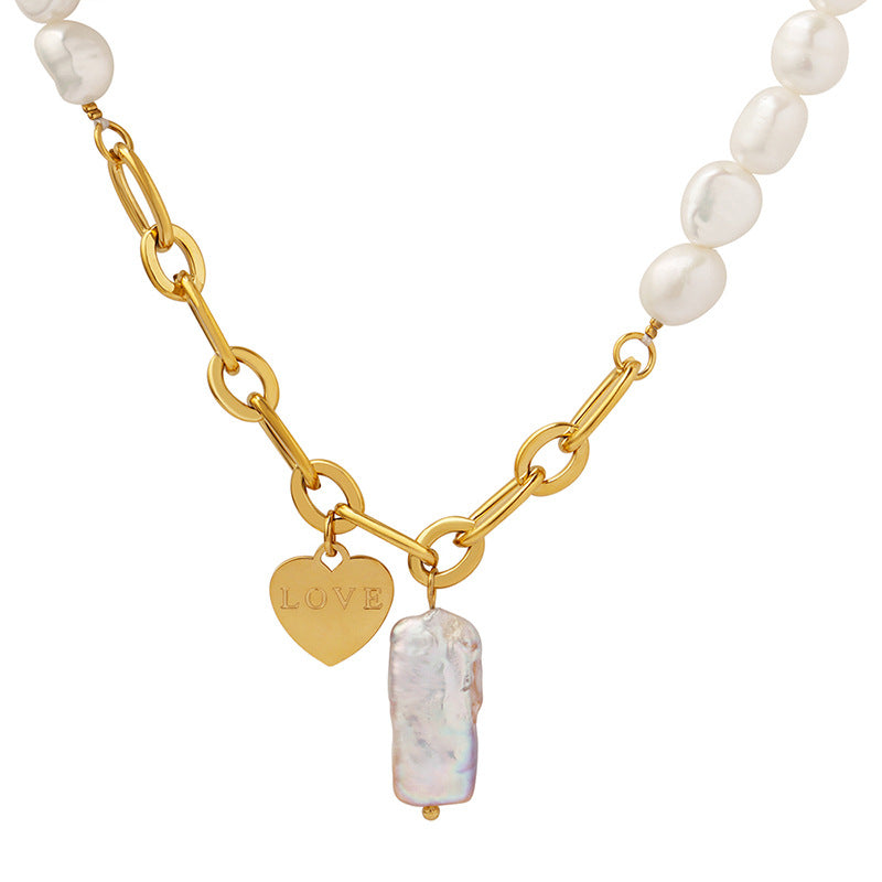 Vivienne pearl love necklace: oval gold links, a LOVE heart tag and a baroque pearl drop on white