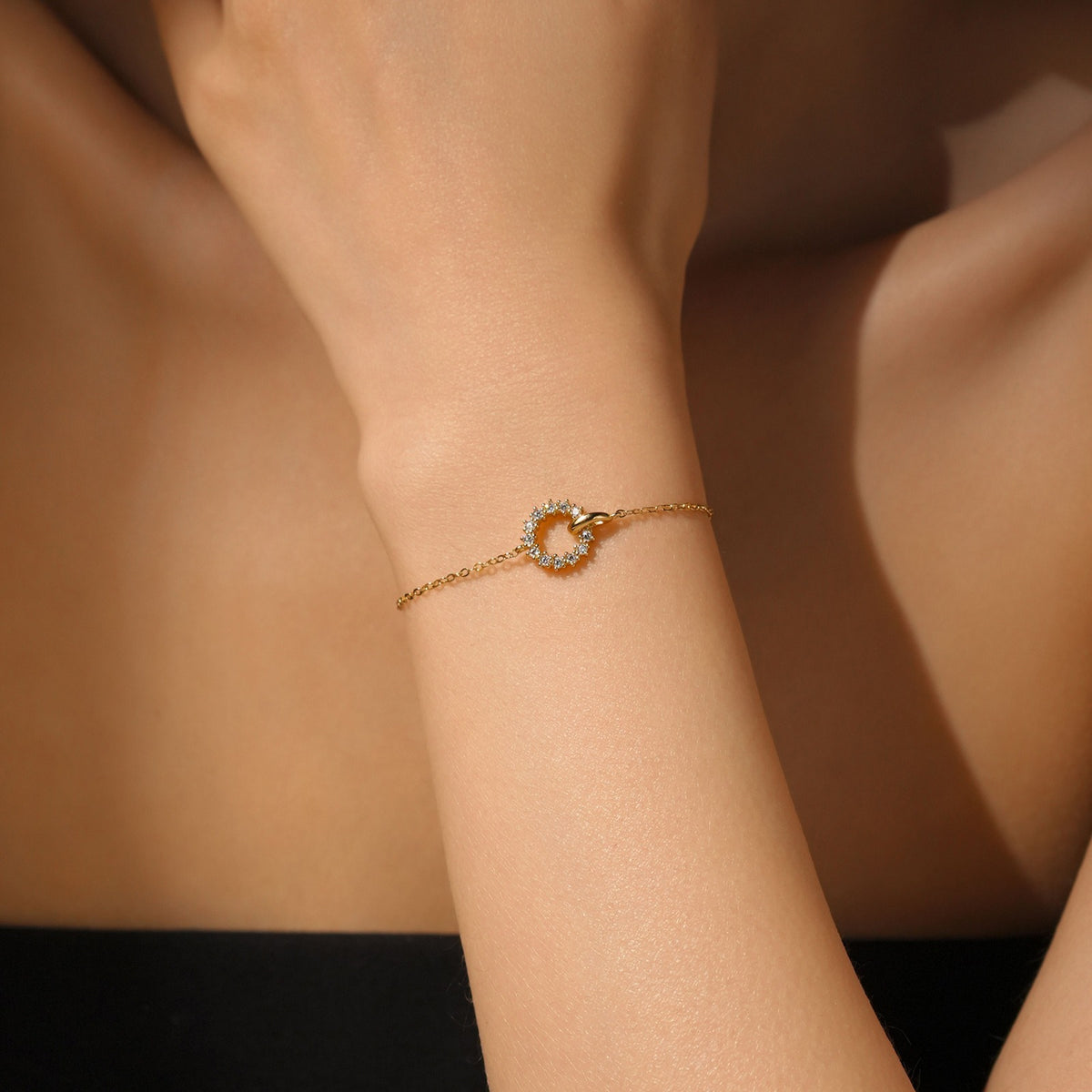 Isla Linked Circle bracelet in gold on the wrist, a crystal-set circle linked to a small polished loop