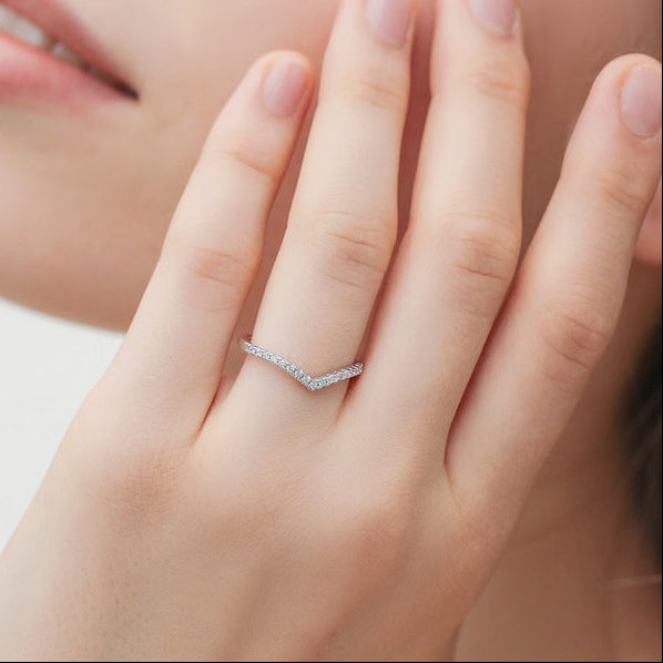 Hand wearing the Ariana V pavé ring, a silver chevron band lined with tiny crystals