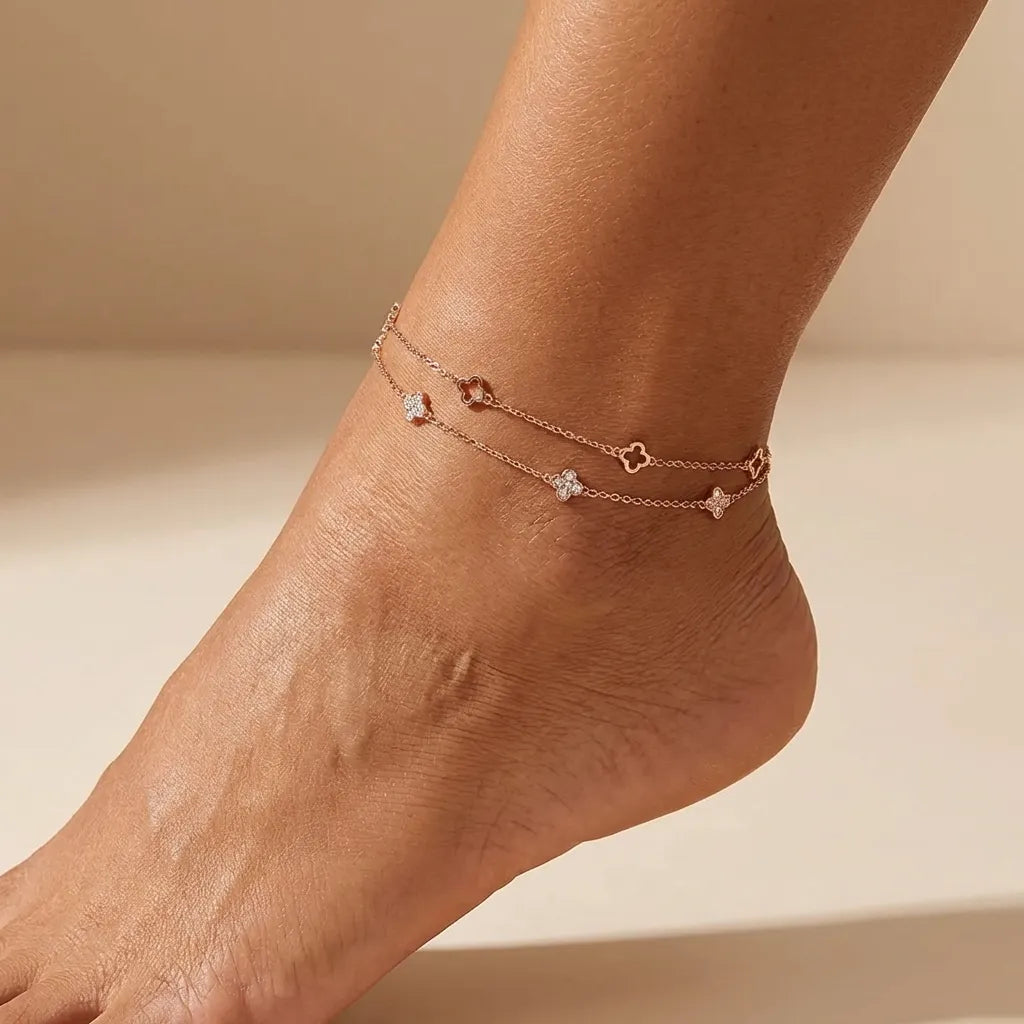 Ariana clover anklet in rose gold, two chains with open clover outlines and crystal clovers on the ankle