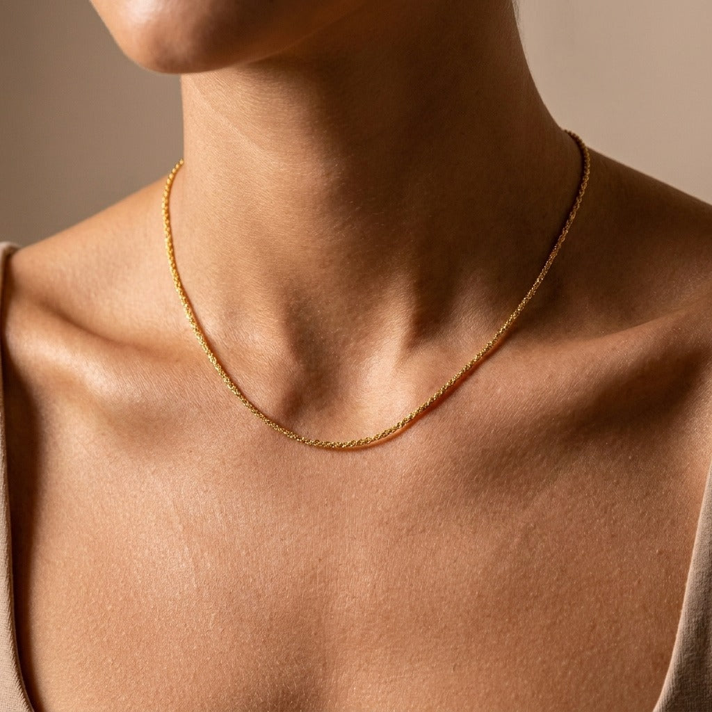 Woman wearing the Abigail slim gold rope chain necklace along the collarbone