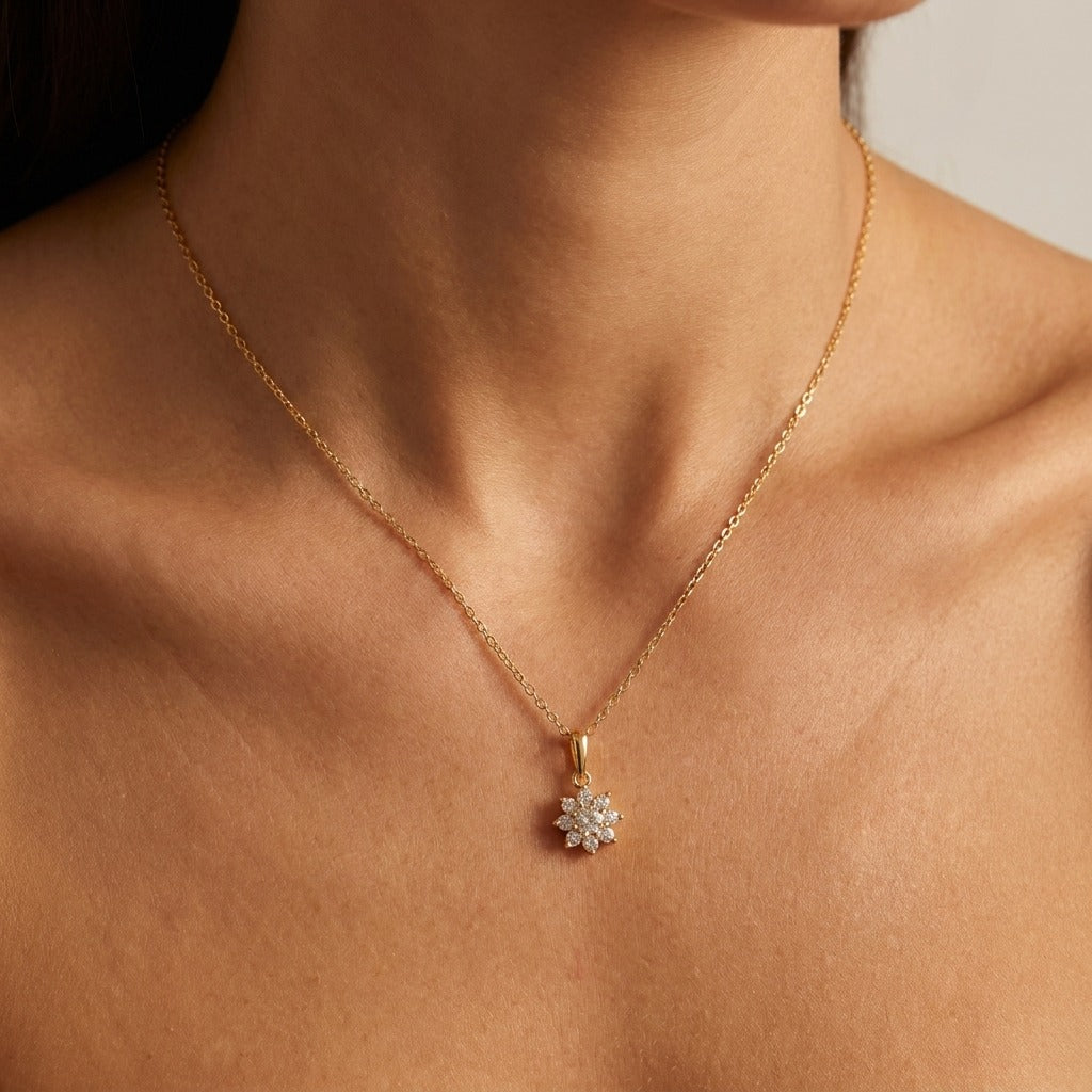 Woman wearing the Elisa crystal flower gold necklace, a clustered flower pendant below the collarbone