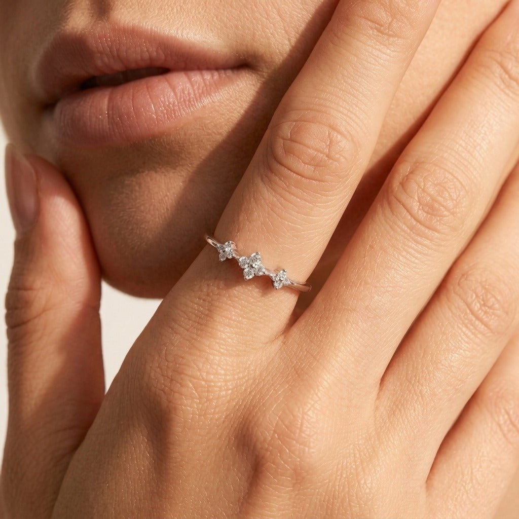 Woman wearing the Lydia clovers ring in silver with three crystal clovers across the band