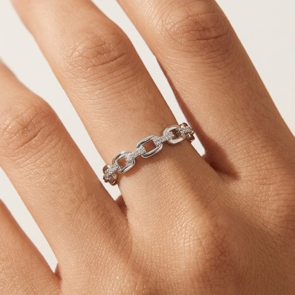 Ava link silver ring worn on the finger, open rectangular links joined by crystal-set bars