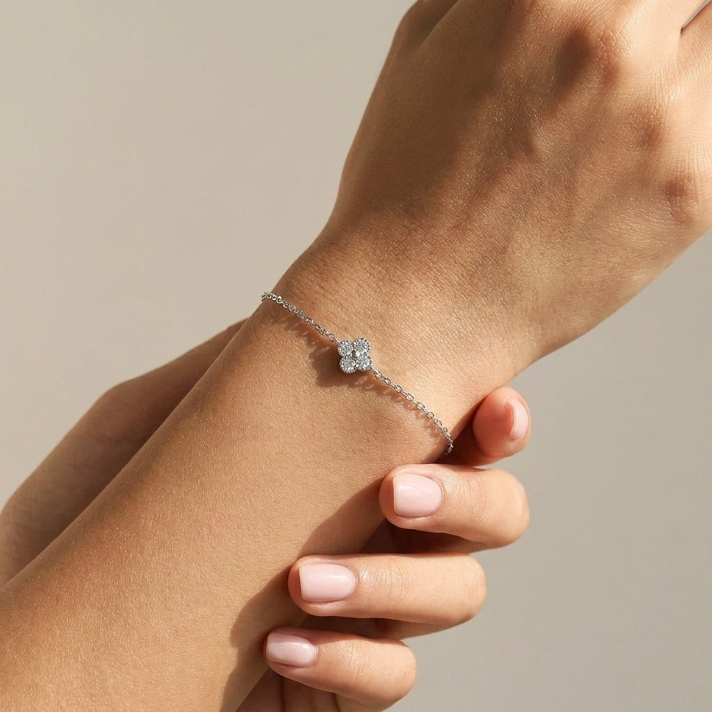 Woman wearing the Aurélie silver clover bracelet, a crystal-set clover charm resting on the wrist