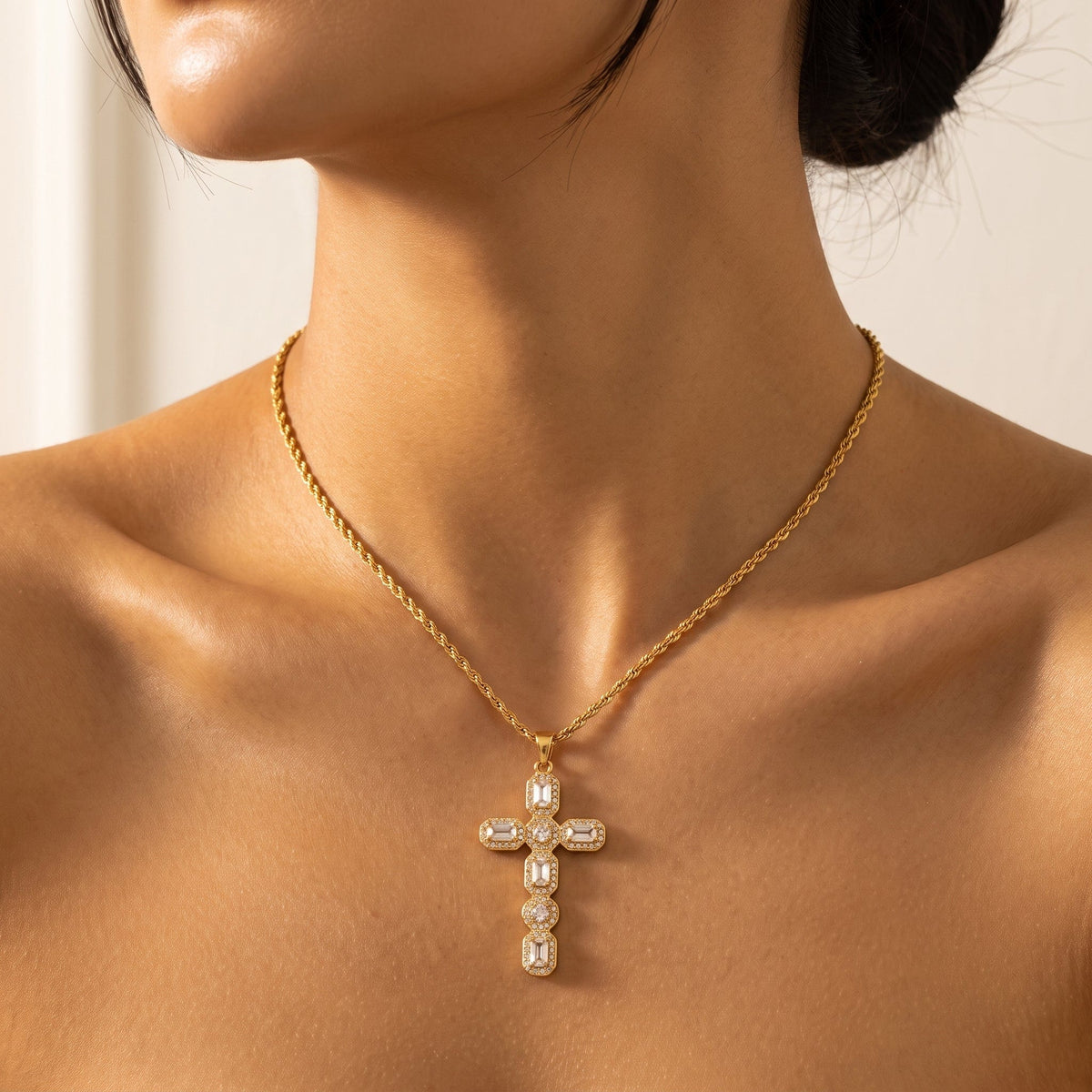 Woman wearing the Flavia halo cross gold necklace at the collarbone