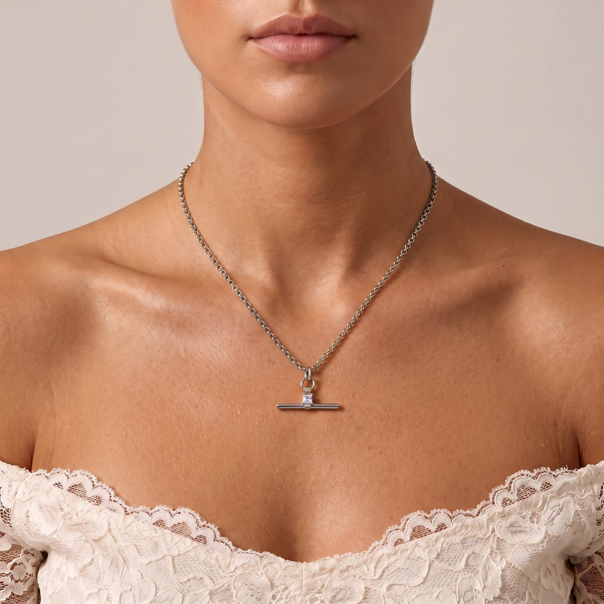 Woman wearing the Joséphine t-bar crystal silver necklace at the collarbone in an off-shoulder dress