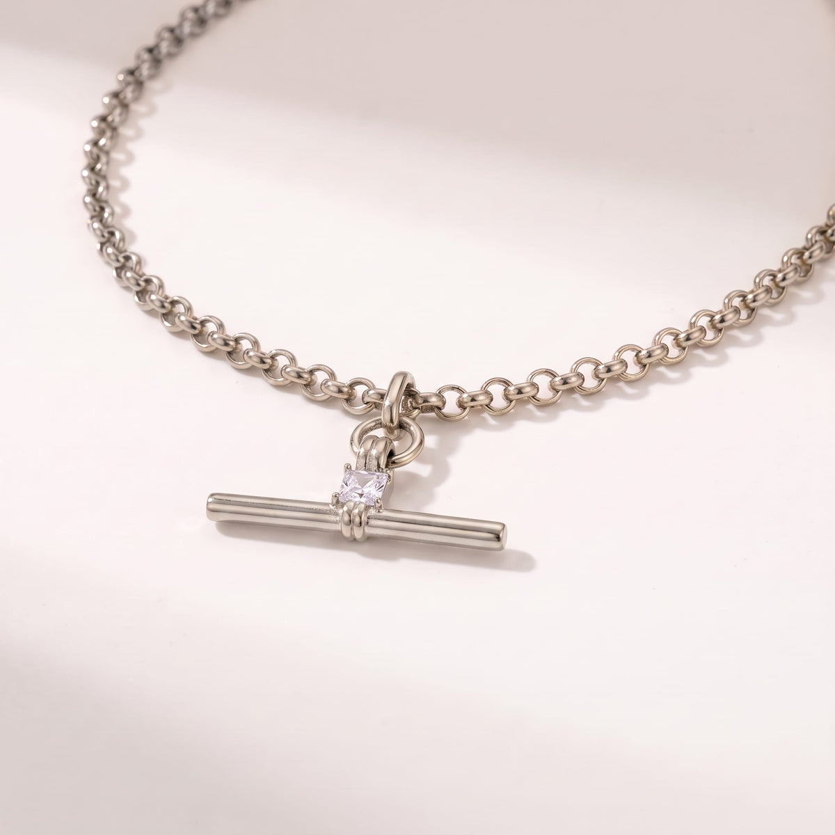 Joséphine t-bar crystal silver necklace on a white surface with soft light and shadows