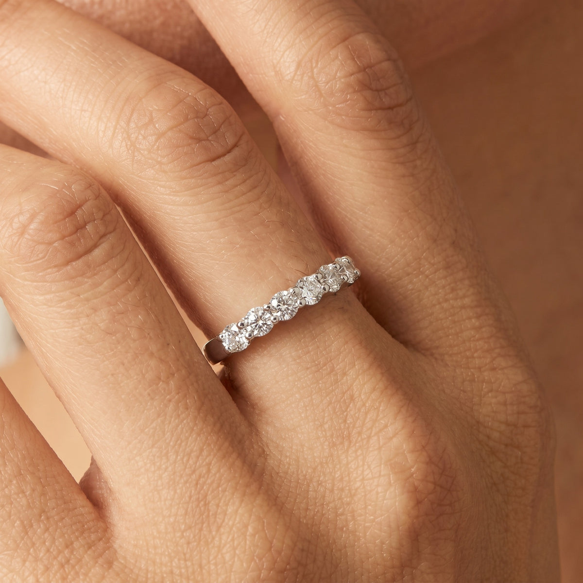 Close view of the Elise eternity silver ring on the hand, five round crystals set in a row