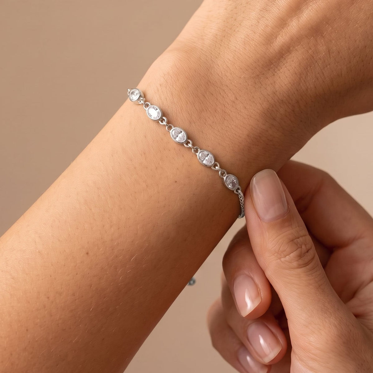 Woman wearing the Marisa oval crystal silver bracelet on the wrist