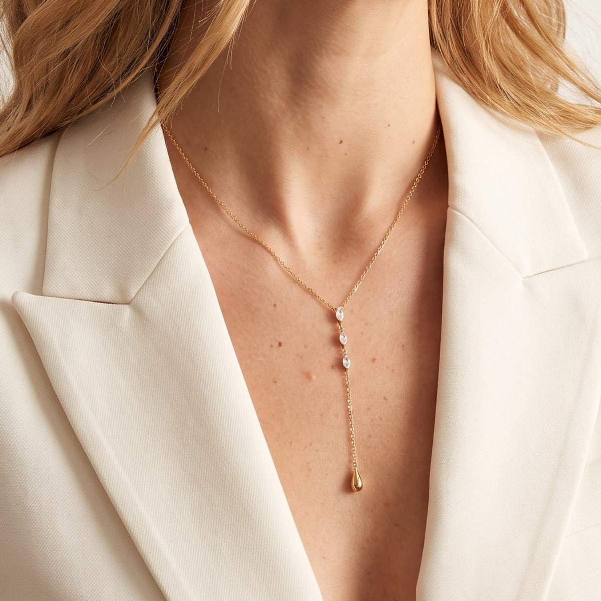 Woman wearing the Rafaella marquise teardrop gold necklace at the collarbone