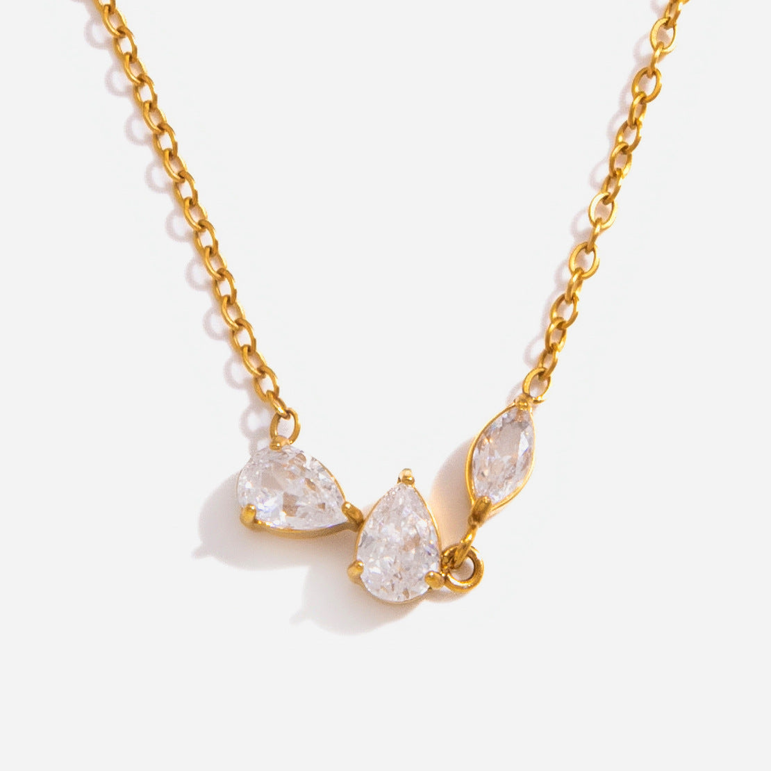 Close-up of the Rosalie cluster of two pear-cut crystals and a marquise on a gold chain